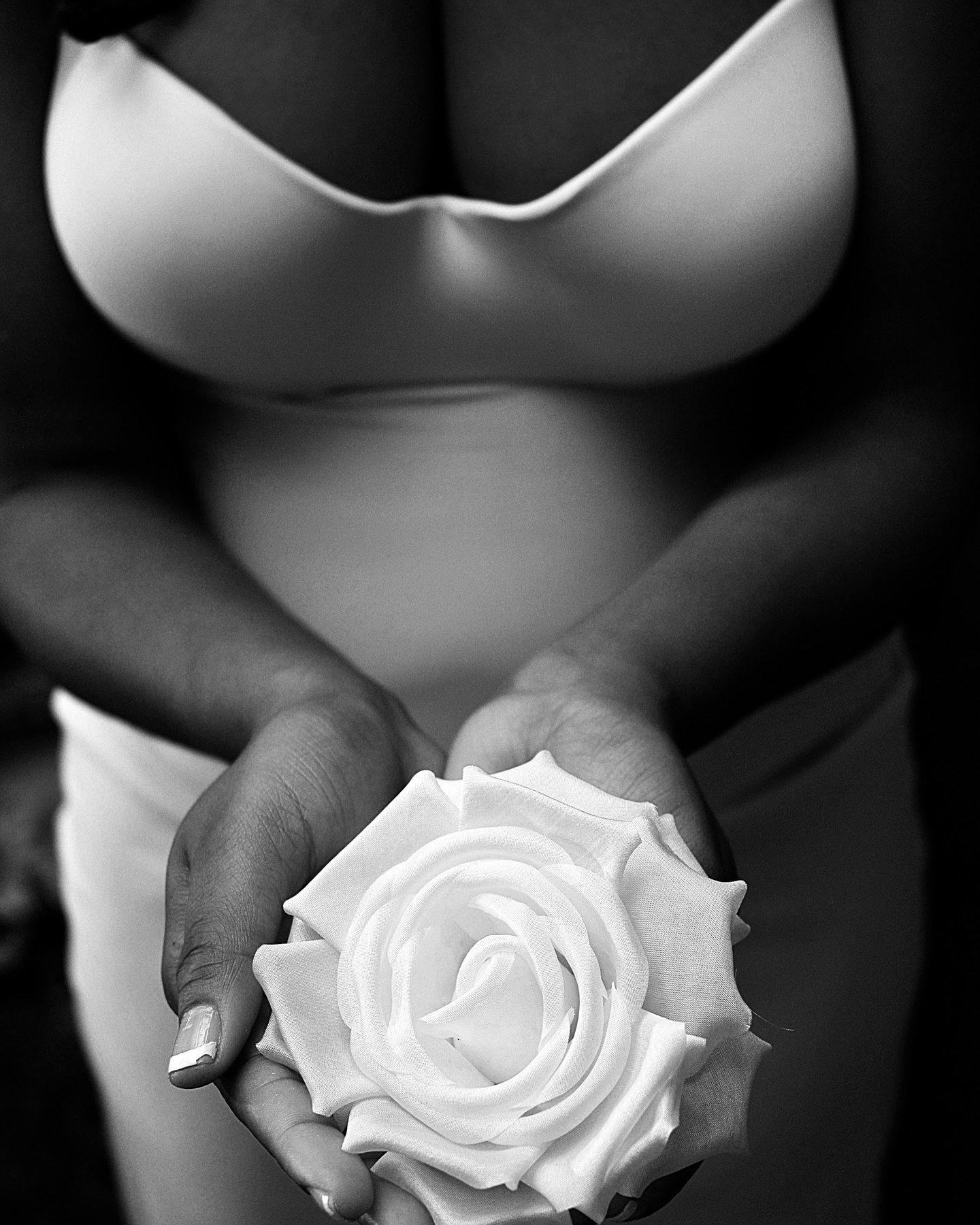 Black-and-white bridal detail with a white rose