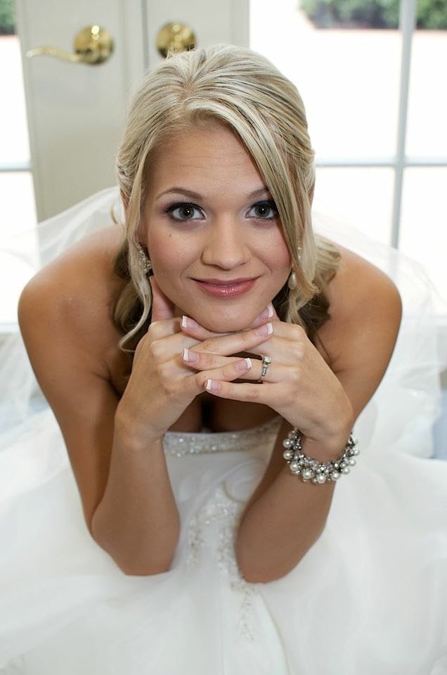 Bride resting her chin on her hands for a playful portrait