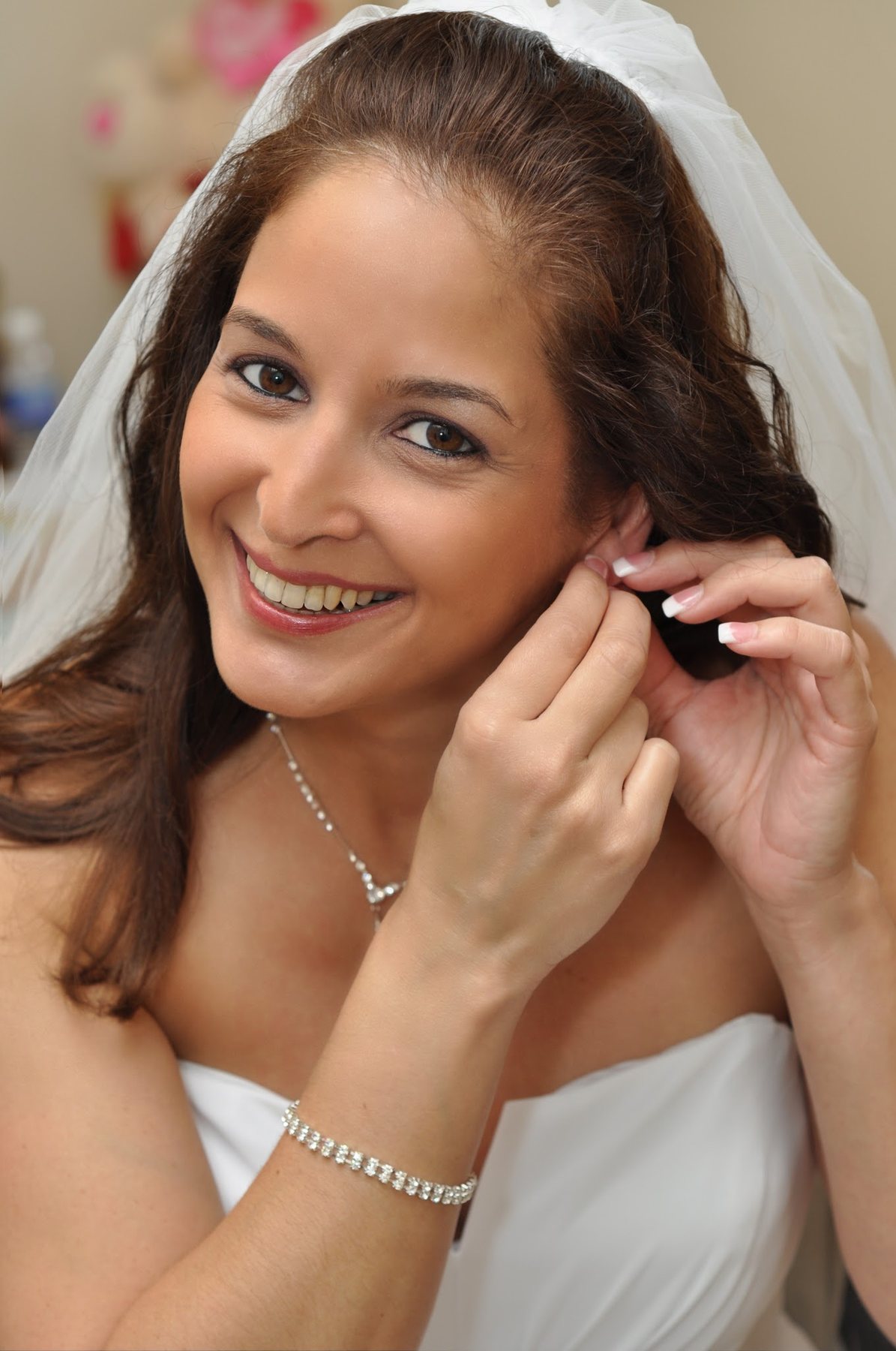 Bride putting on an earring