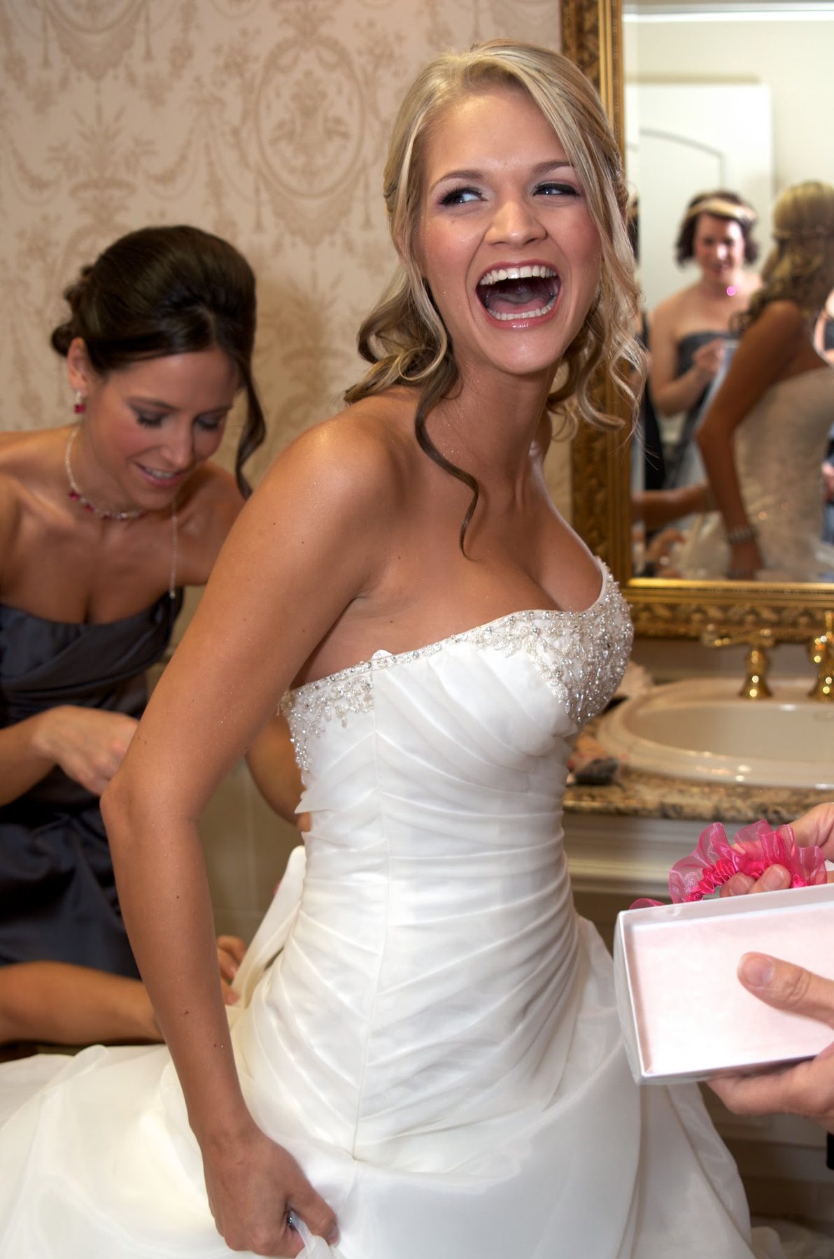 Bride laughing while getting ready