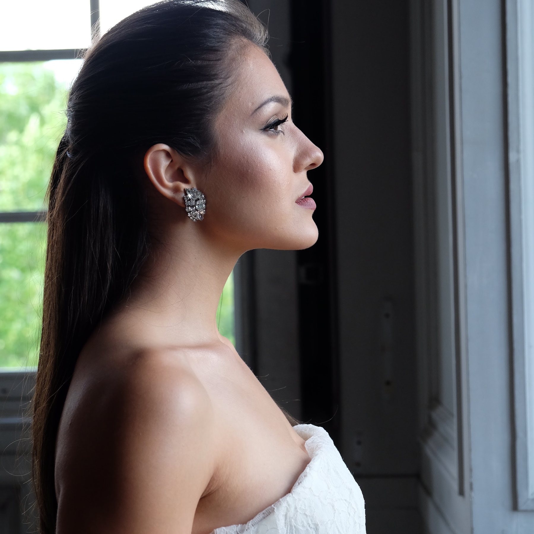 Bride in profile beside a window