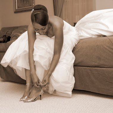 Bride fastening her shoes before the ceremony