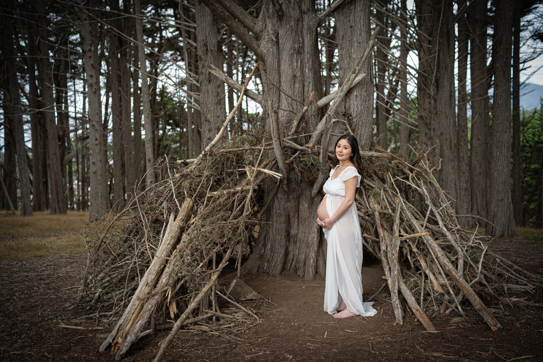 Maternity portrait in a forest clearing