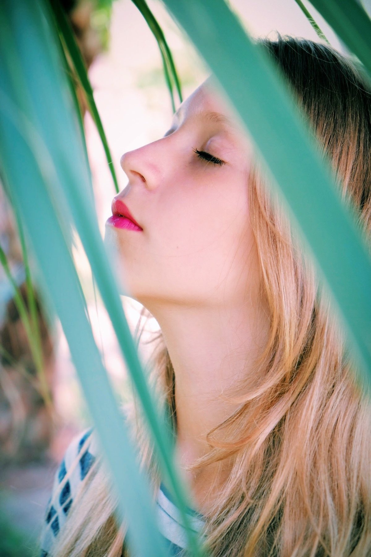 Soft portrait framed by green leaves