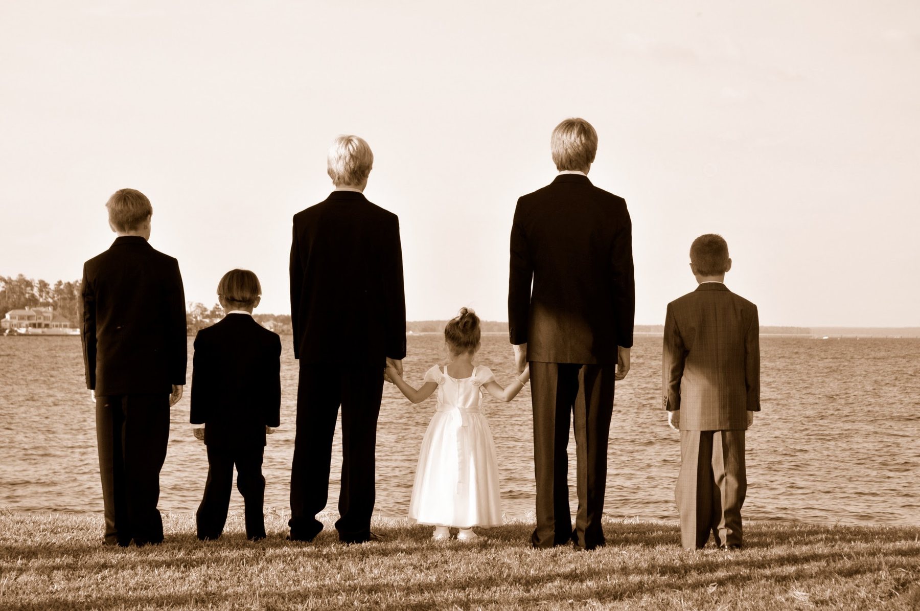 Wedding attendants lined up beside the water