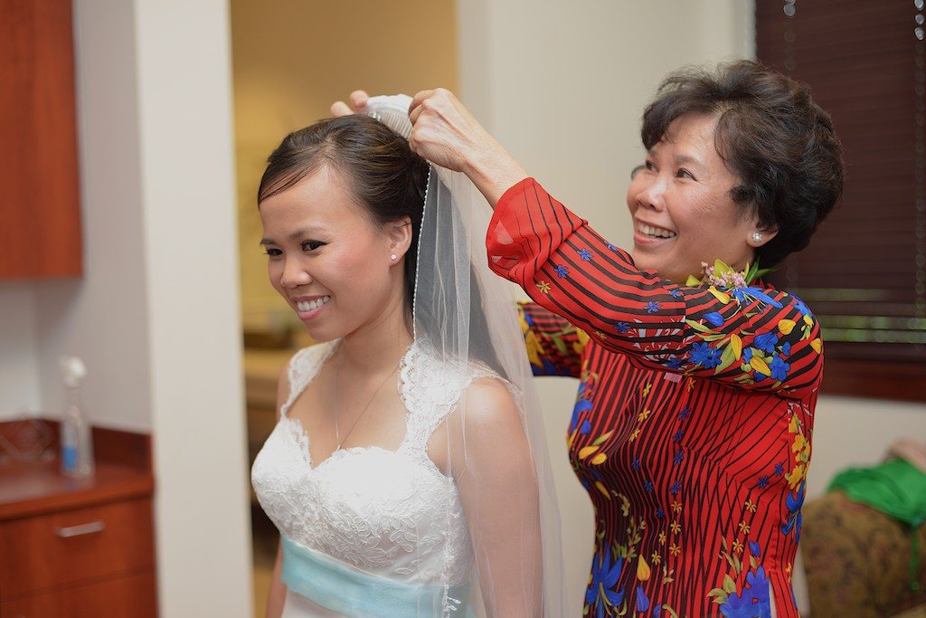 Family member placing a bride's veil